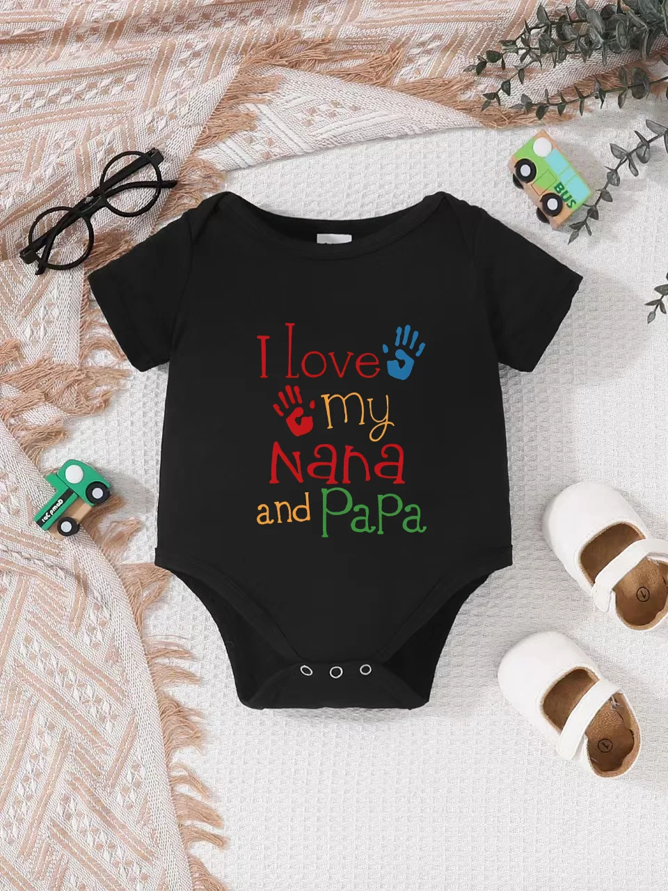 Playful letter-printed baby short-sleeve triangle bodysuit. Button closure for easy dressing