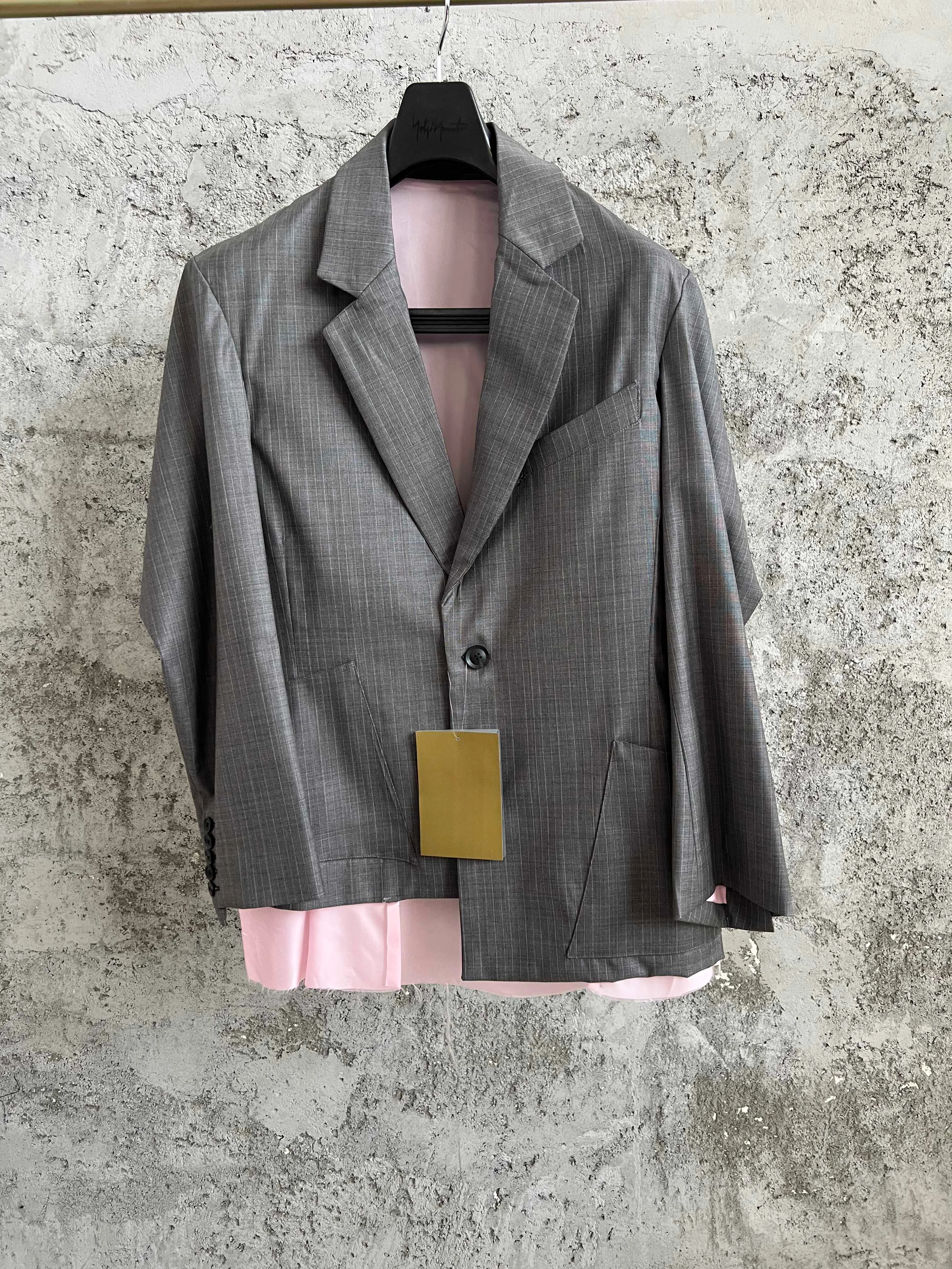 TOP-YAMAMOTO deconstructs the men's straight-cut suit jacket in a smoky ash vertical striped color, a niche designer