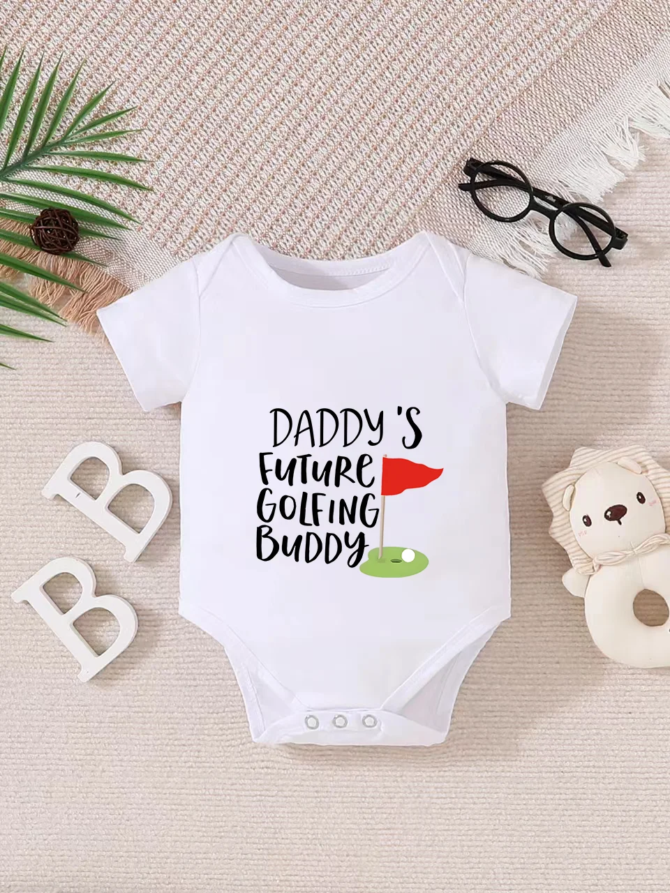 Playful letter-printed baby short-sleeve triangle bodysuit. Button closure for easy dressing, machine washable