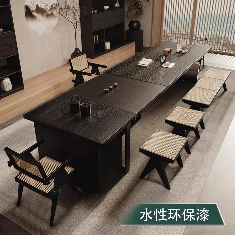 The black  table and chairs are combined, with a  tray and kettle as one