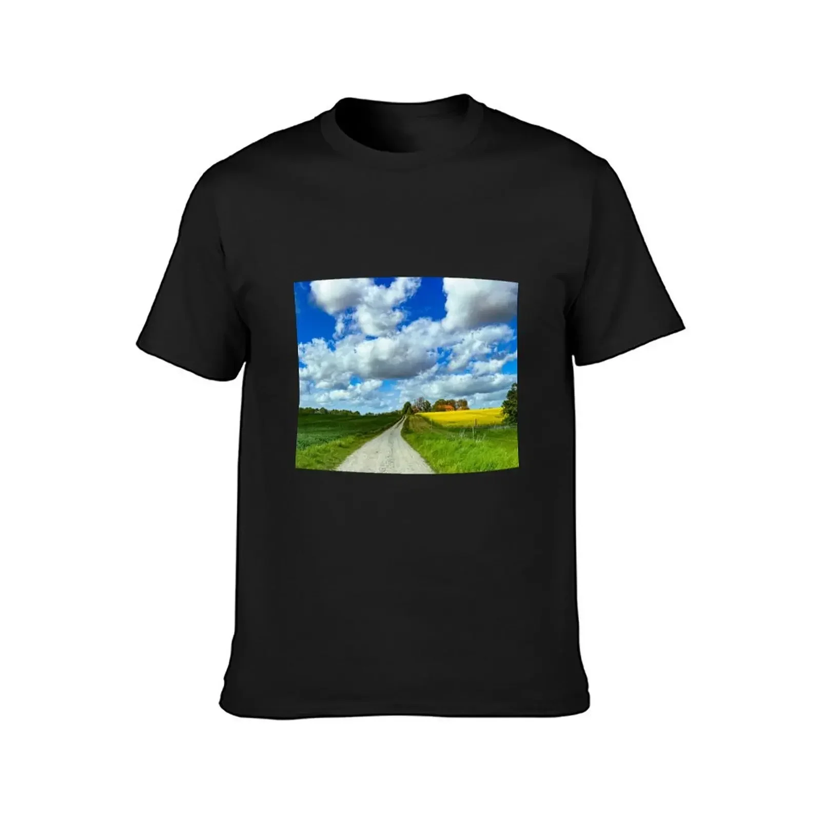 Country lane leading to a manor with a yellow canola field under a blue sky T-Shirt sweat men clothes