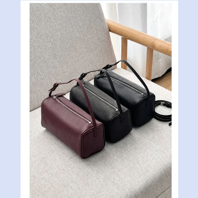 Women's minimalist style cowhide single shoulder messenger bag with soft and supple handle and underarm pencil holder