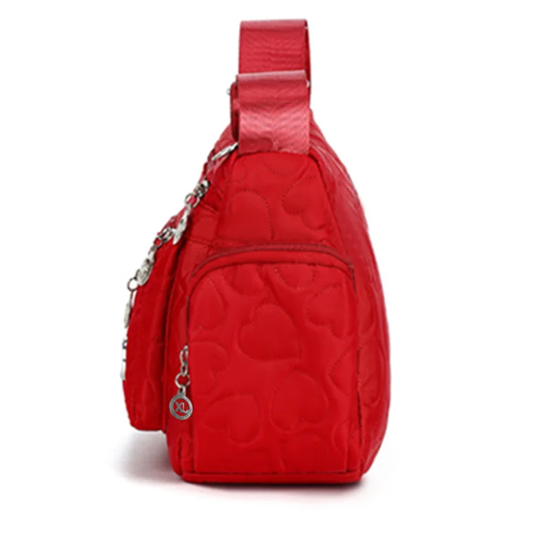 Schicke, verzierte Damen-Umhängetasche für den täglichen Pendelverkehr. Stilvolle, leichte, lässige Nylontasche mit Herzdetail und mehreren Taschen – Detail 2