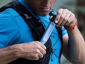 Trail runner packing LifeStraw Personal filter into running vest