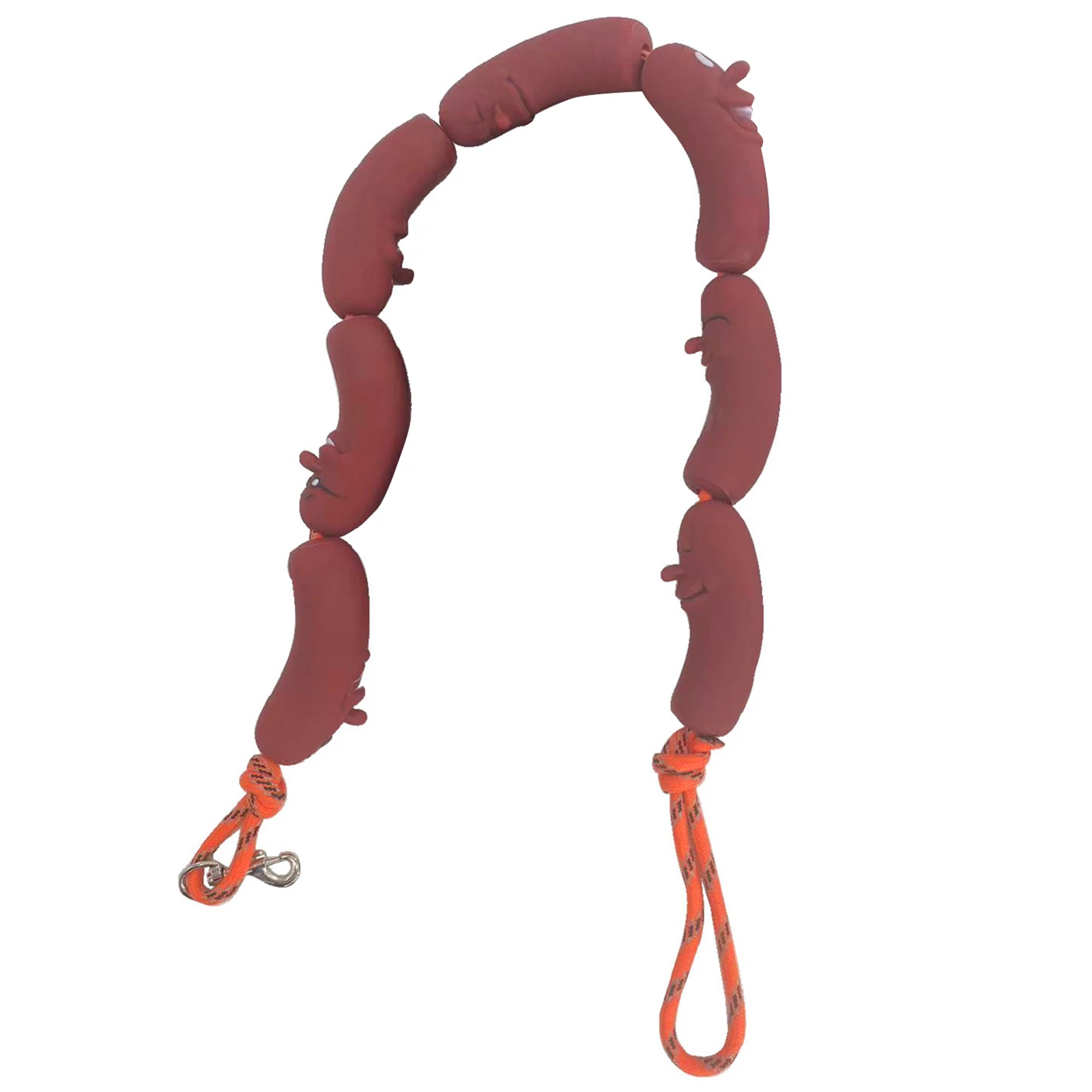 Funny sausage shaped dog leash connected to a small brown dachshund walking on a park pathway.