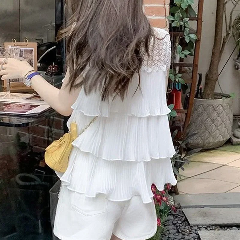 Camicia in chiffon senza maniche bianca scavata per le donne Estate nuova top trendy chic da strada con foglie di loto a pieghe larghe e impiombate
