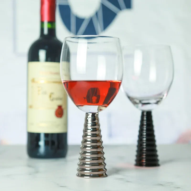 

American style model room decorated with red wine champagne cup, dining table table, goblet, black threaded styling cup