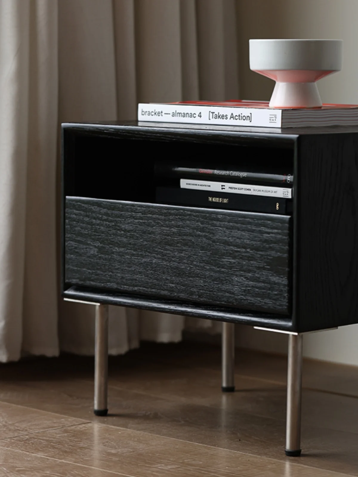 The bedroom bedside table is minimalist, modern and creative, with stainless steel legs and a black color scheme. The bedside image 5