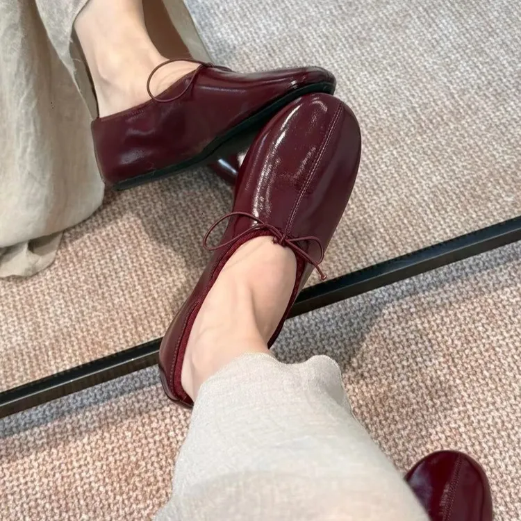Echte Leder-Ballerinas im französischen Stil mit weicher Sohle, roter Farbe, eleganter Schleife, flacher runder Zehenpartie und flachem Luffa-Schuhprofil.