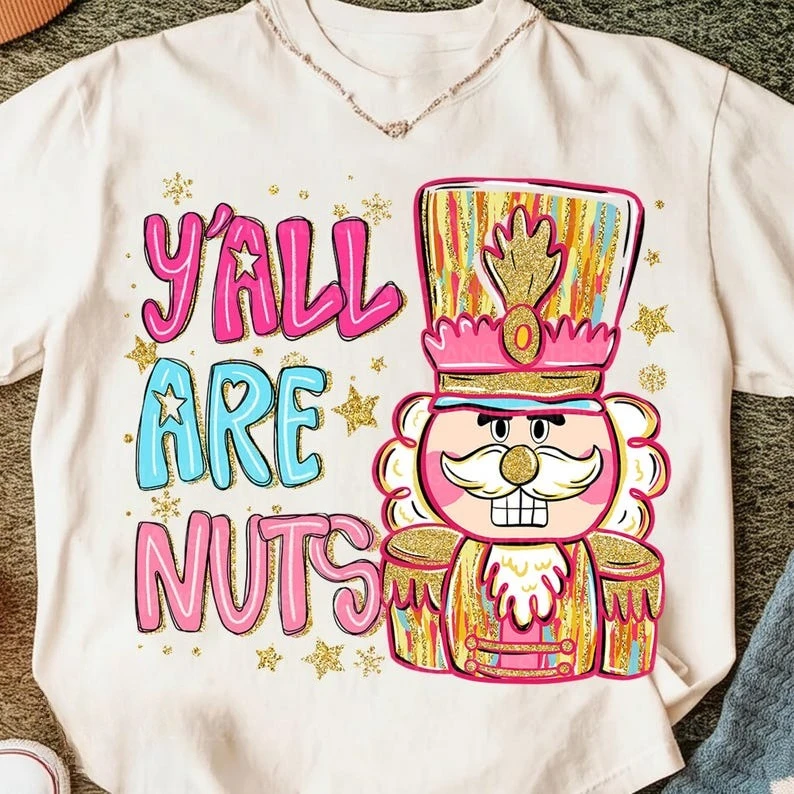 Y'all Are Nuts Coquette كسارة البندق Preppy عيد الميلاد Png السكر البرقوق الجنية المكسرات حول Brushstroke Crewneck تي شيرت مطبوع بلايز