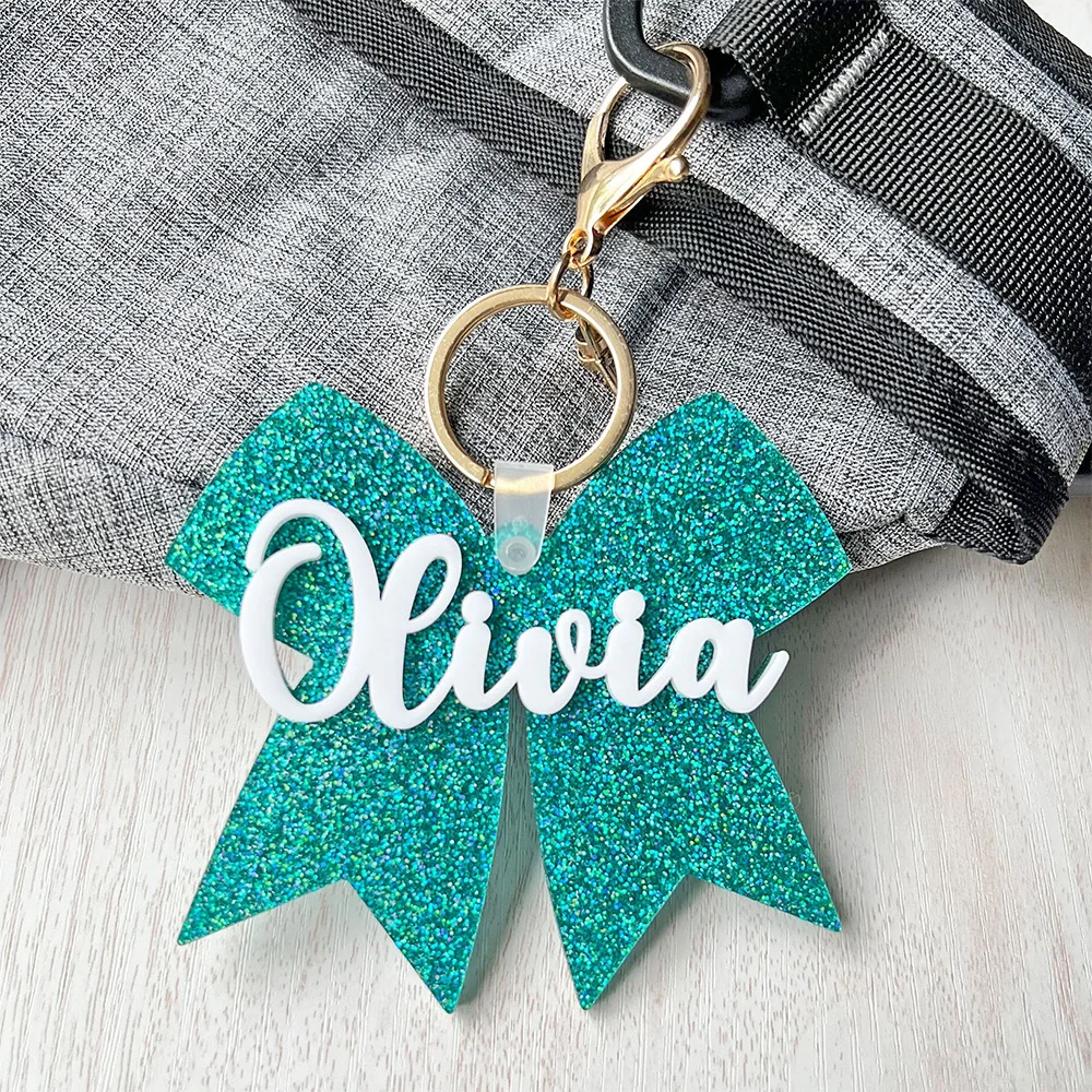 Custom acrylic winter and autumn keys, cheerleading bow packaging cards, cheerleading bow with names, custom acrylic keychains,