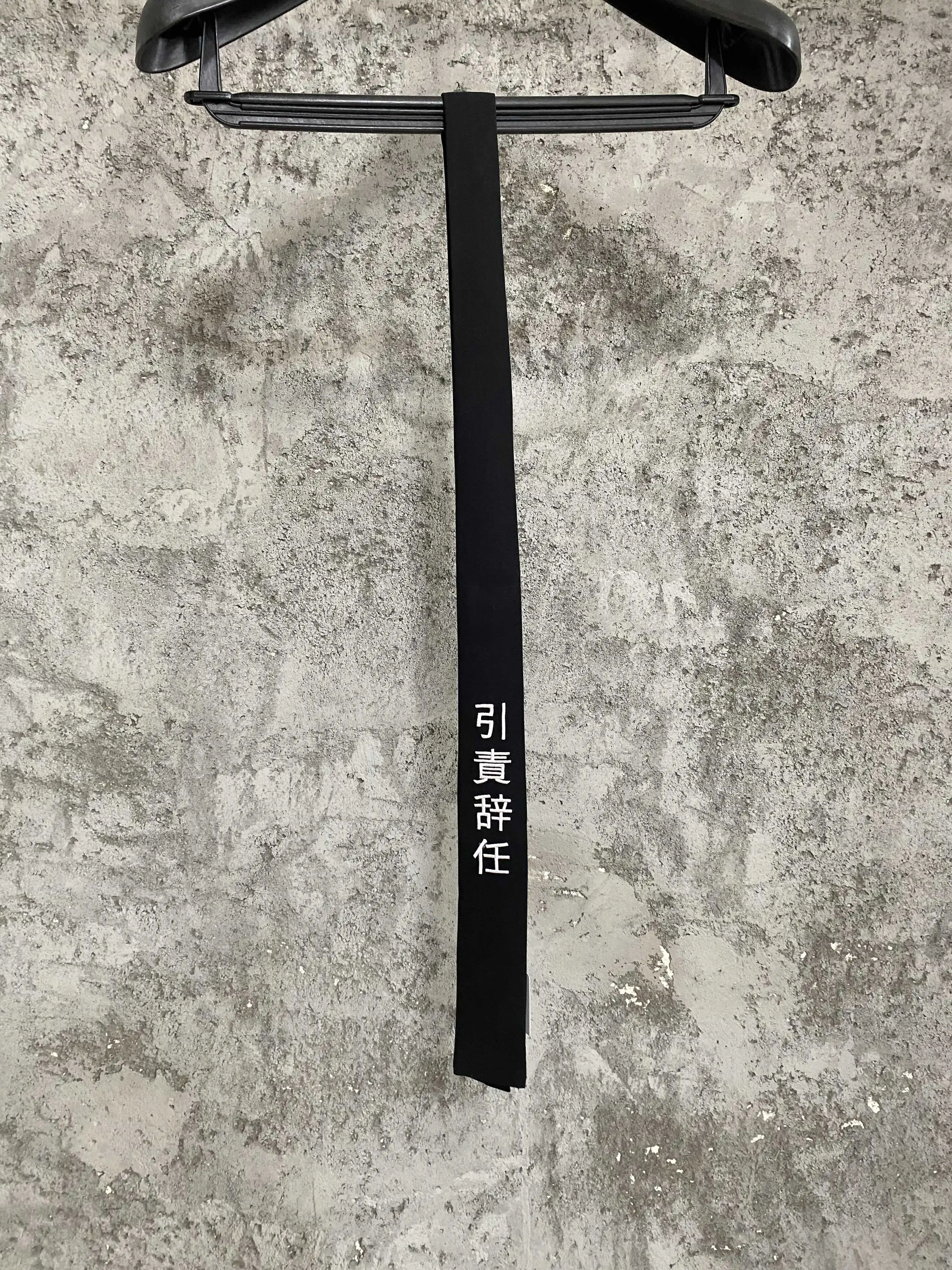 A man and a woman who created a Chinese-embroidered wool tie have resigned from their original dark-themed design