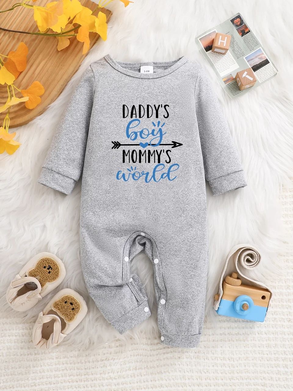 A baby long-sleeved onesie with interesting letter prints. It features a buttoned design for easy putting on and taking off