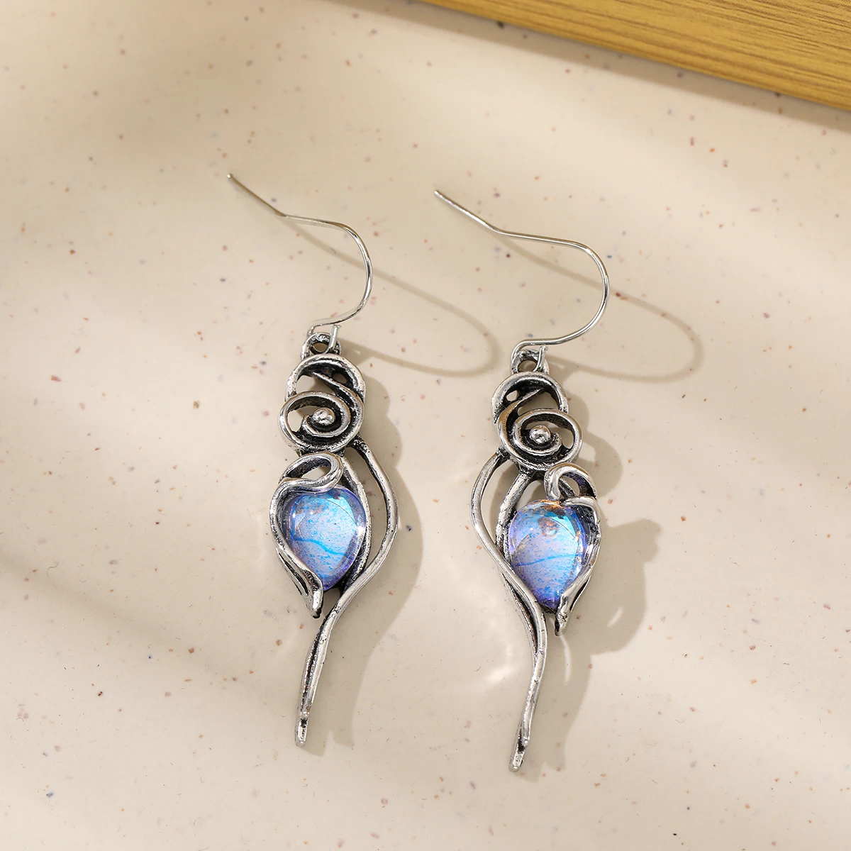 Elegant swirling vortex pattern drop-shaped artificial gemstone earrings for ladies, suitable for parties and gatherings.