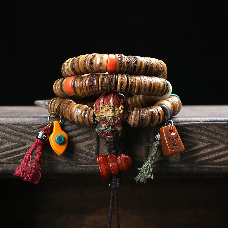 Tibetan-style 108-bead prayer beads made from camel bone, featuring a Black Dharma King design with yak bone and cloud-patterned