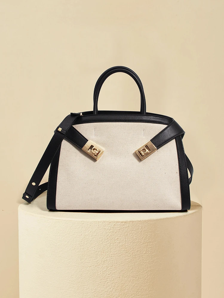 

A fashionable and casual multi-functional business bag made of black leather and white canvas, including cross-body bags, should