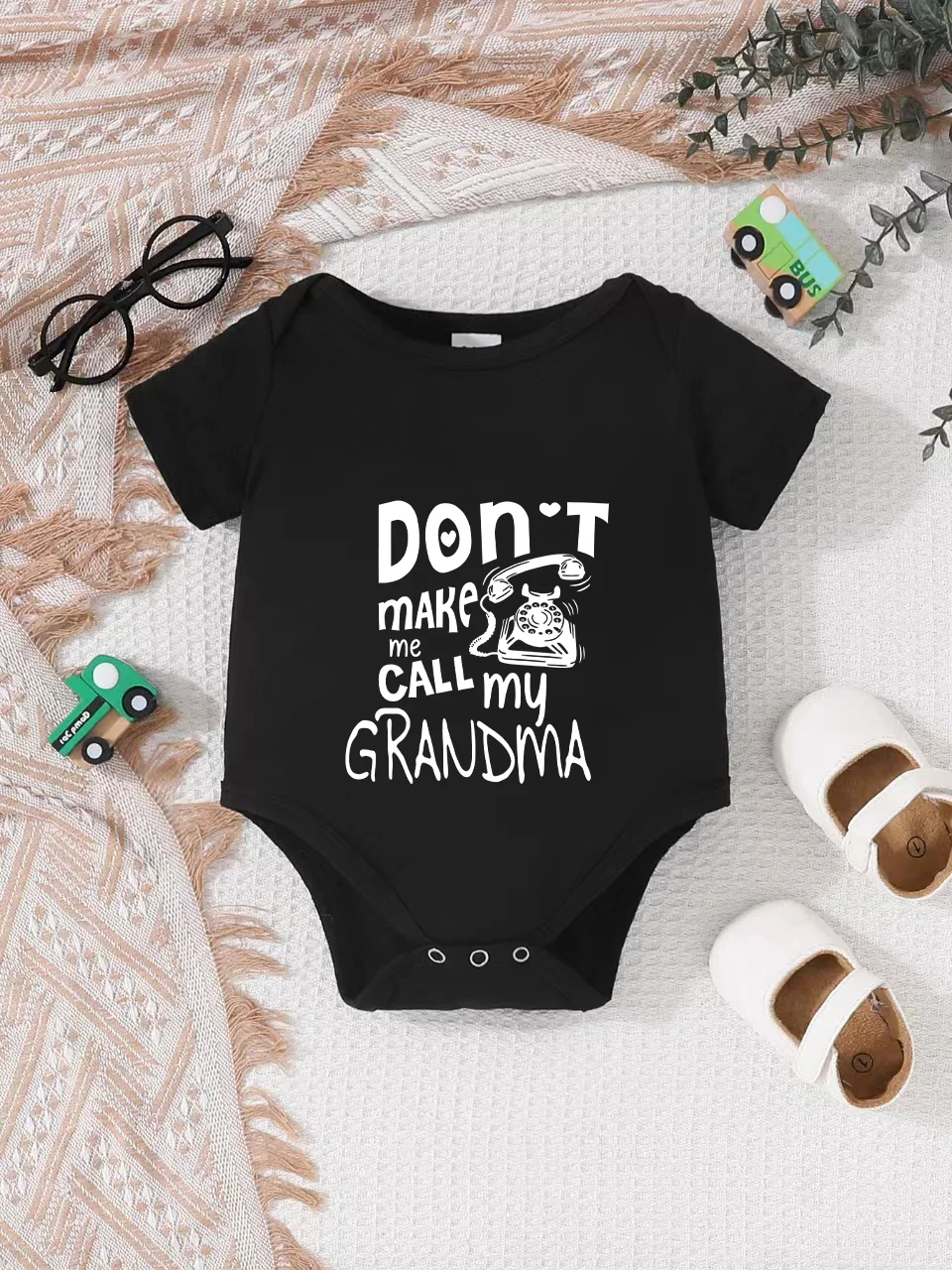 Playful letter-printed baby short-sleeve triangle bodysuit. Button closure for easy dressing