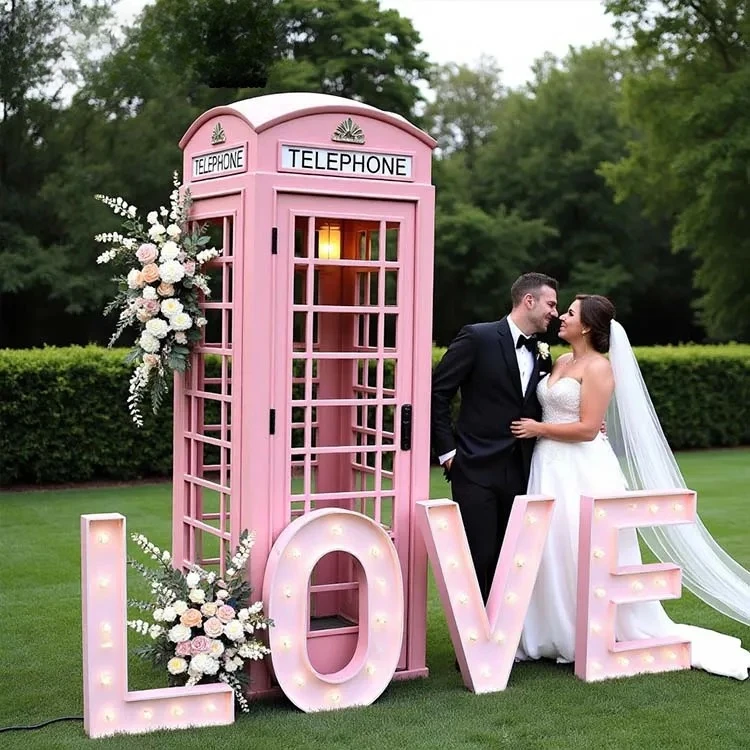 Vintage Metal English Iron Pink Phone Booth With Flowers And Subtitles On A Photographic Background, Suitable For Weddings