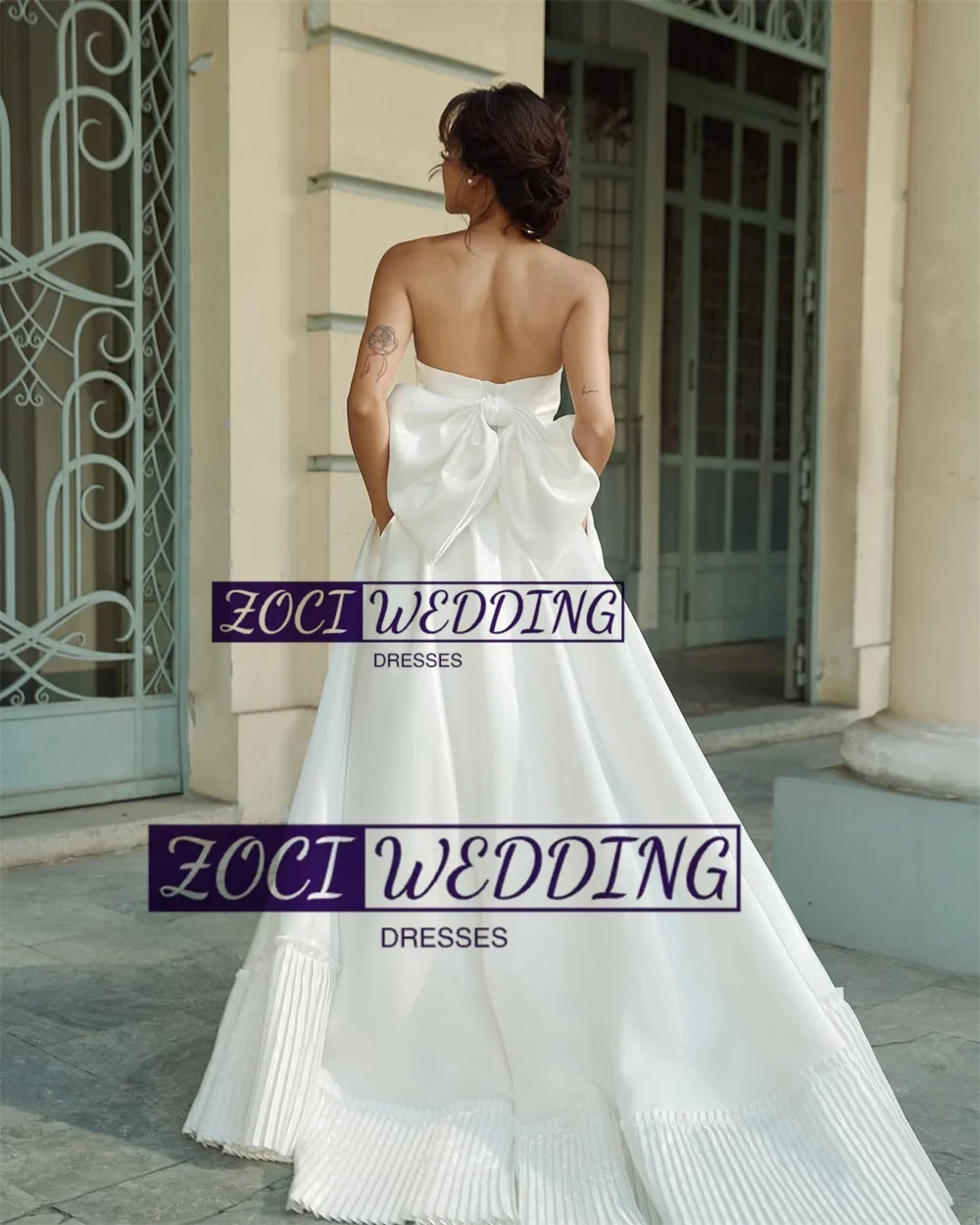 Zoci Moderne trägerlose Korea-Hochzeitskleider, Satin-Falten, mehrlagiges Fotoshooting-Kleid, maßgeschneidertes, rückenfreies Brautpartykleid mit großer Schleife