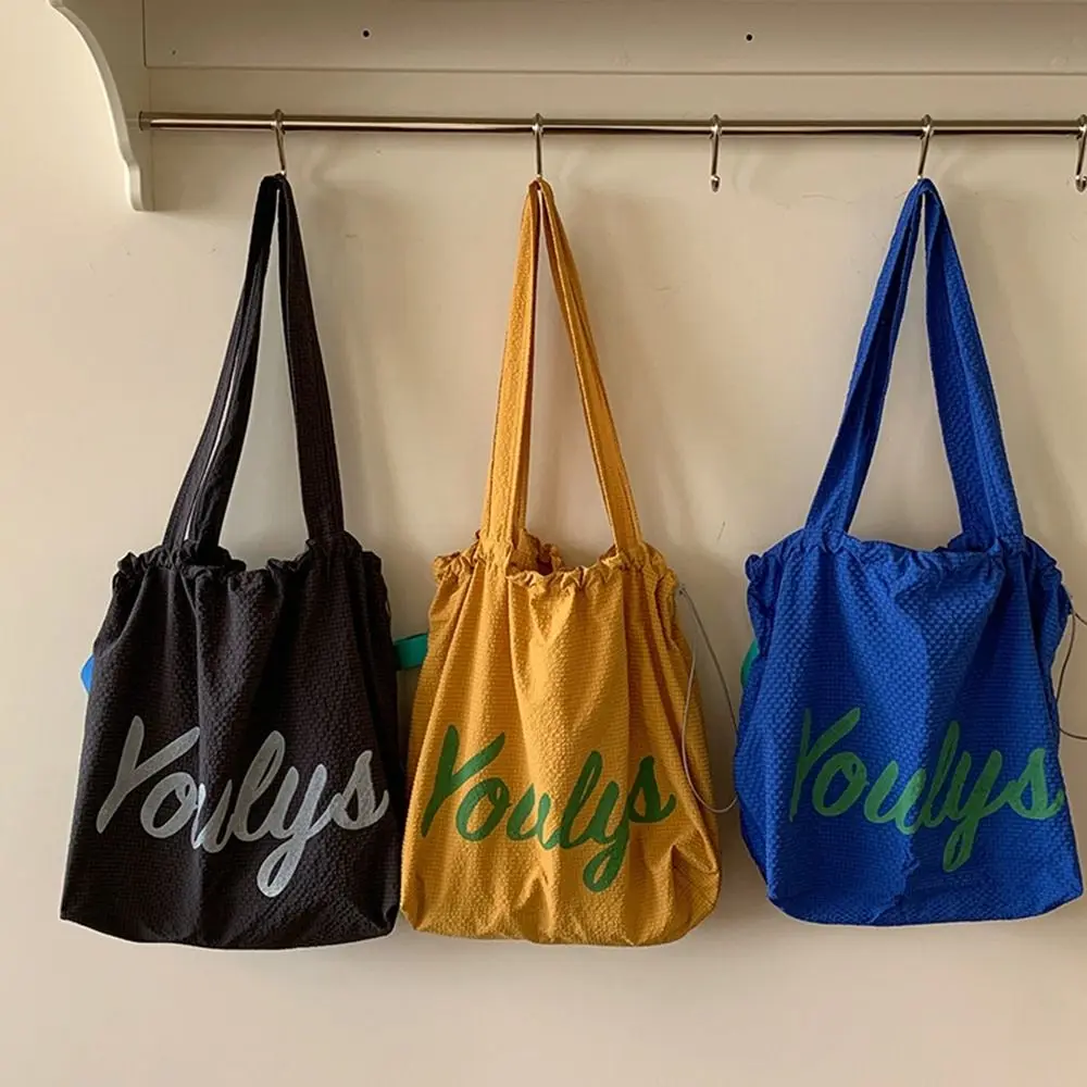 

Canvas Drawstring Tote Bag Large Capacity Korean Style Nylon Shoulder Bag Shopping Bag Beach Bag Letter Printed Handbag Daily