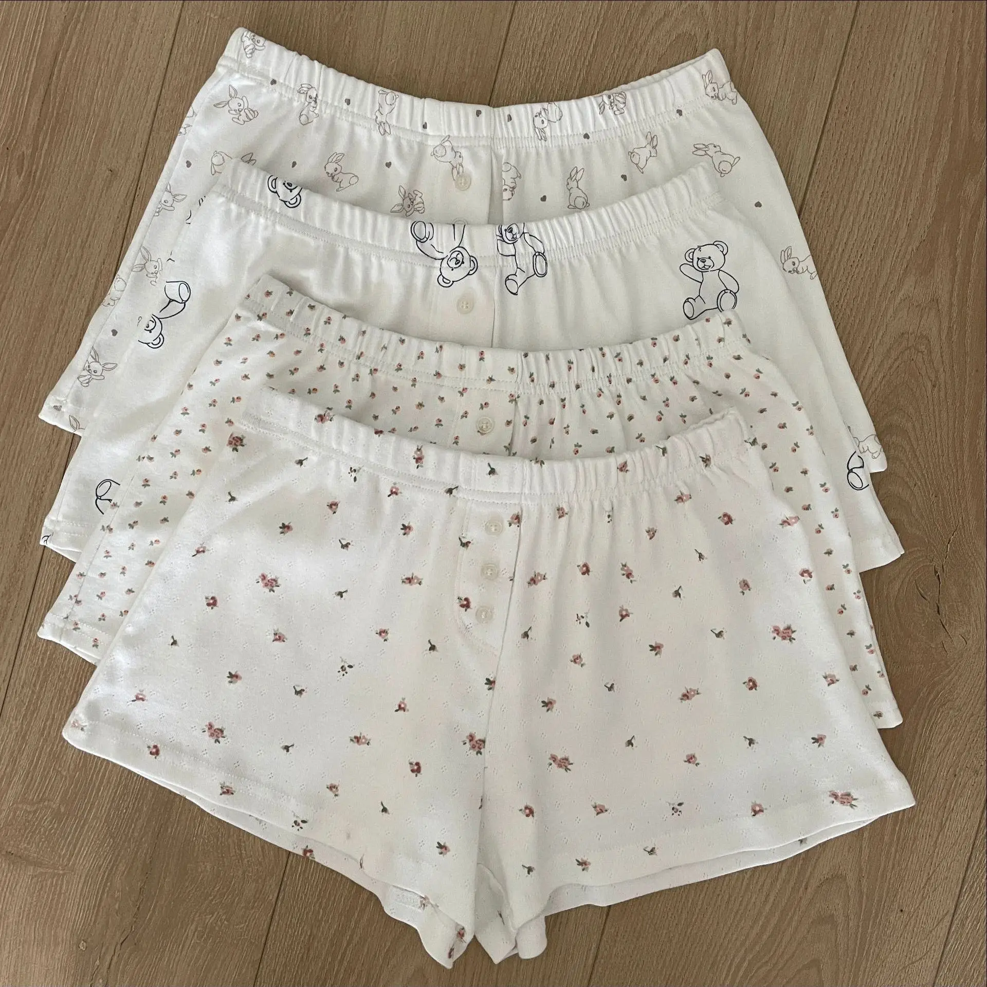 Pantalones cortos con estampado Floral blanco con ojales para mujer, novedad de verano, pantalones cortos de algodón con cintura elástica y tres botones, pantalones cortos cómodos informales para el hogar
