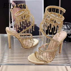 Eilyken-Sandalias doradas con diamantes de imitación para mujer, zapatos de verano con tacón de aguja, Correa envolvente, Punta abierta