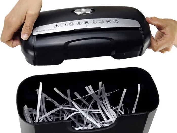 A black paper shredder opened after its work is completed.
