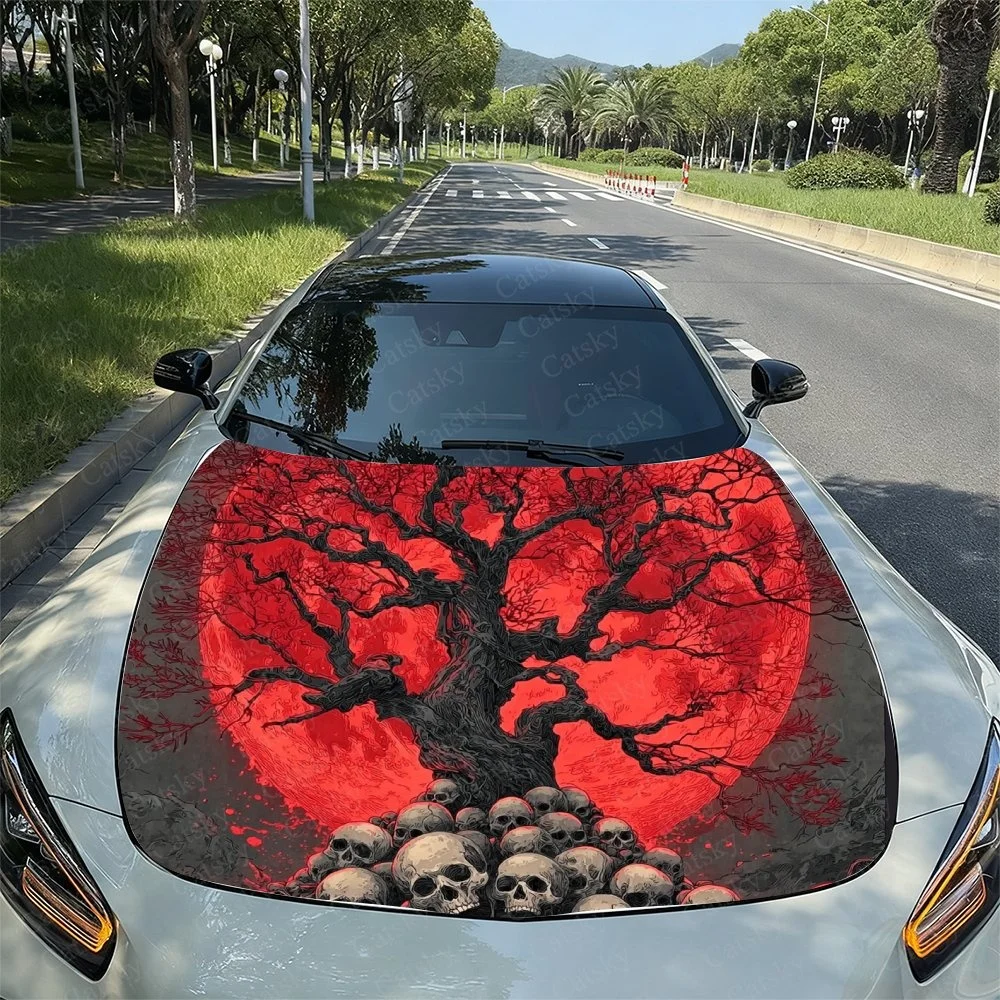 This striking car hood wrap features a bold red sun with intricate black branches and skulls at the base, creating a dramatic an
