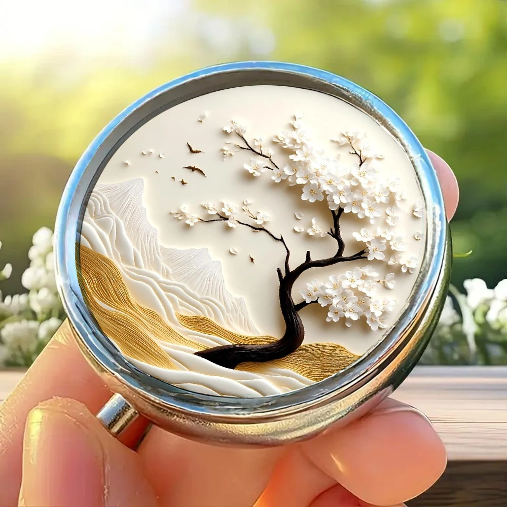 Pill Organizer Box, Designed with White Cherry Blossom Trees, Featuring Mountain and Bird Patterns, Divided into Three Compartments It Is Portable, Safe, and Easy to Fit in Your Wallet or Purse, Making It an Ideal Choice for Use on the Go.