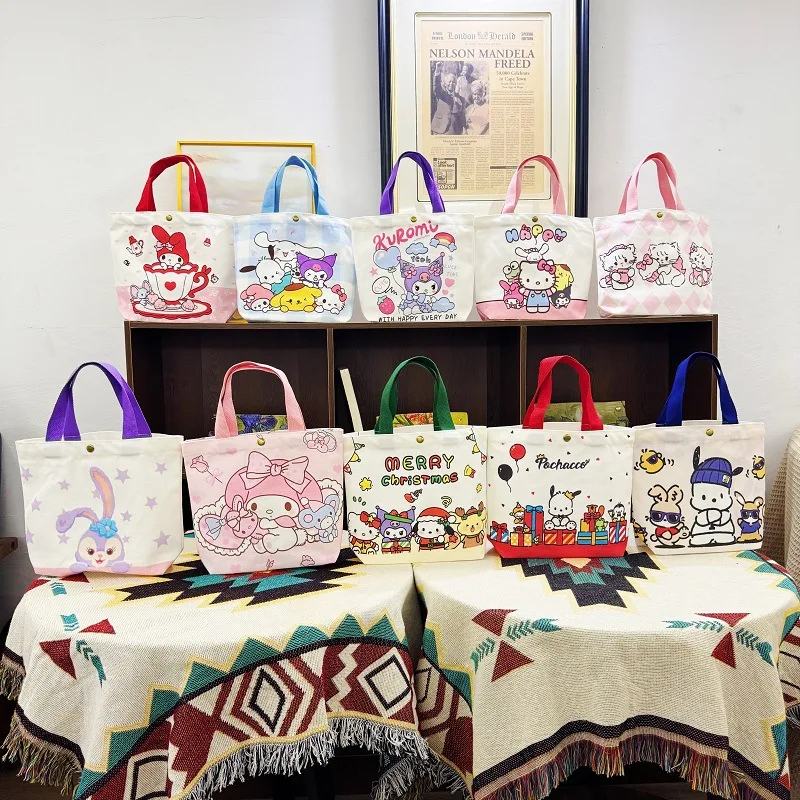 

2026 Nuevo bolso de mano de tela con estilo, bolso de transporte de libros para estudiantes de Hello Kitty de dibujos animados,