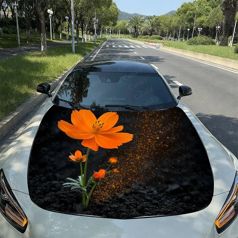 Vibrant orange flower with green stems and leaves on a black background, adorned with sparkling golden dots. Perfect for car hoo