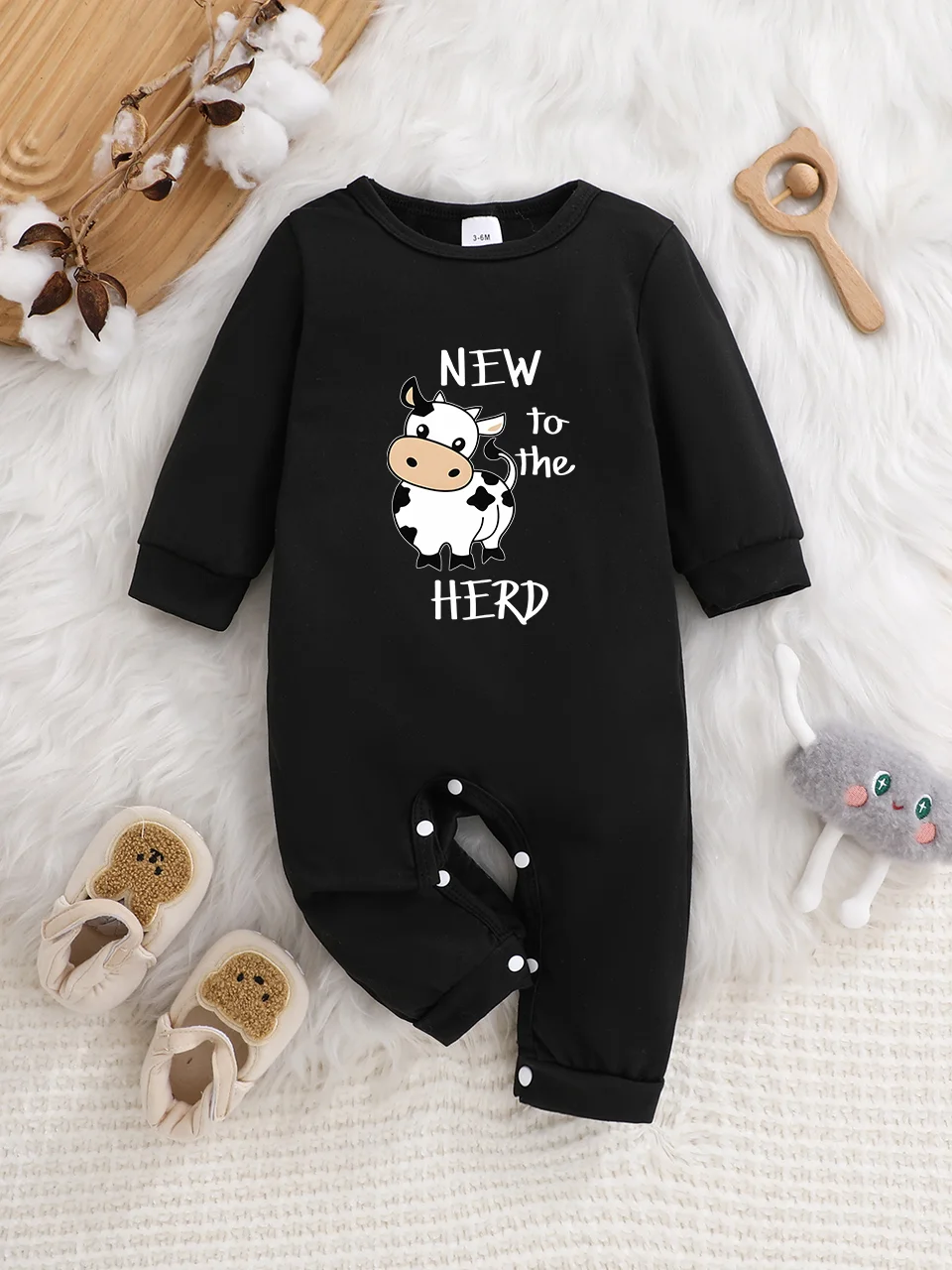 A baby long-sleeved onesie with interesting letter prints. It features a buttoned design for easy putting on and taking off