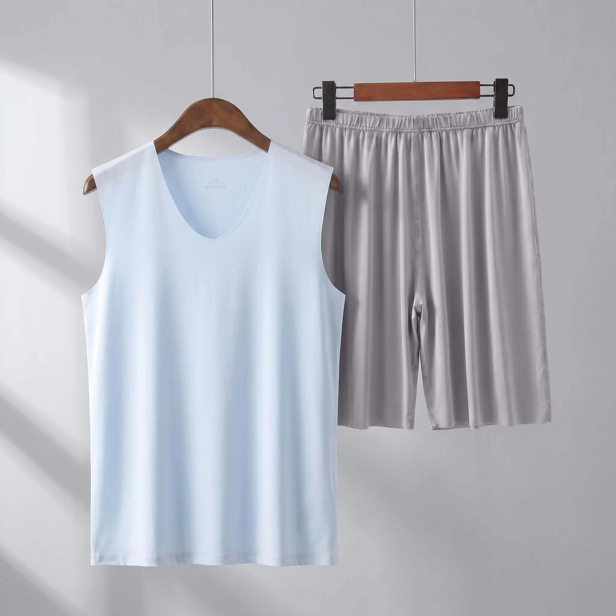 Light blue vest + gray shorts