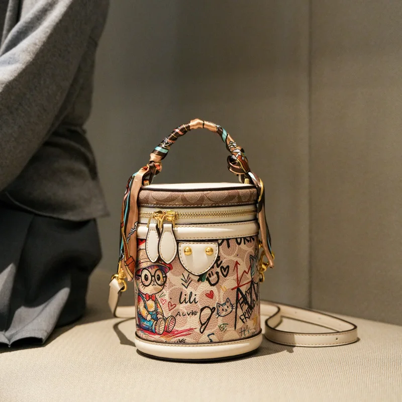 Vintage and Luxury Handheld Bucket Bag with Delicate Cartoon Graffiti and Beautiful Scarves 2026 Women New Fashion Crossbody Bag