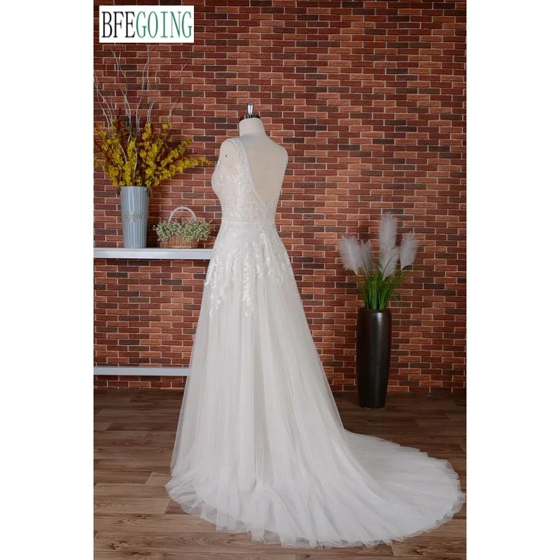 Vestidos de novia de una línea Cola capilla Vestidos de novia con apliques de encaje sin mangas hasta el suelo con cuello en V personalizados