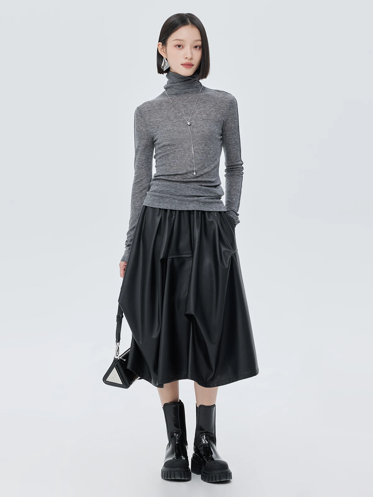 Nowa damska spódnica na jesień i zimę, czarna, asymetryczna, o średniej długości, elastyczna, z wysokim stanem, ze skóry ekologicznej (PU).