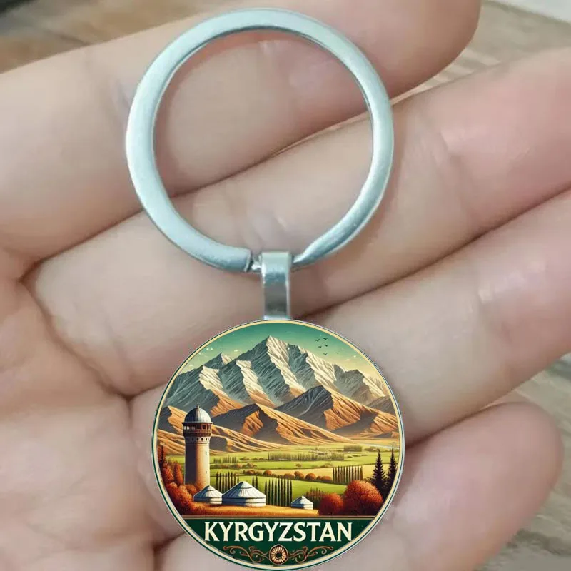 

The keychain showcases the majestic mountains, grasslands, and traditional architecture of Kyrgyzstan, conveying the unique char