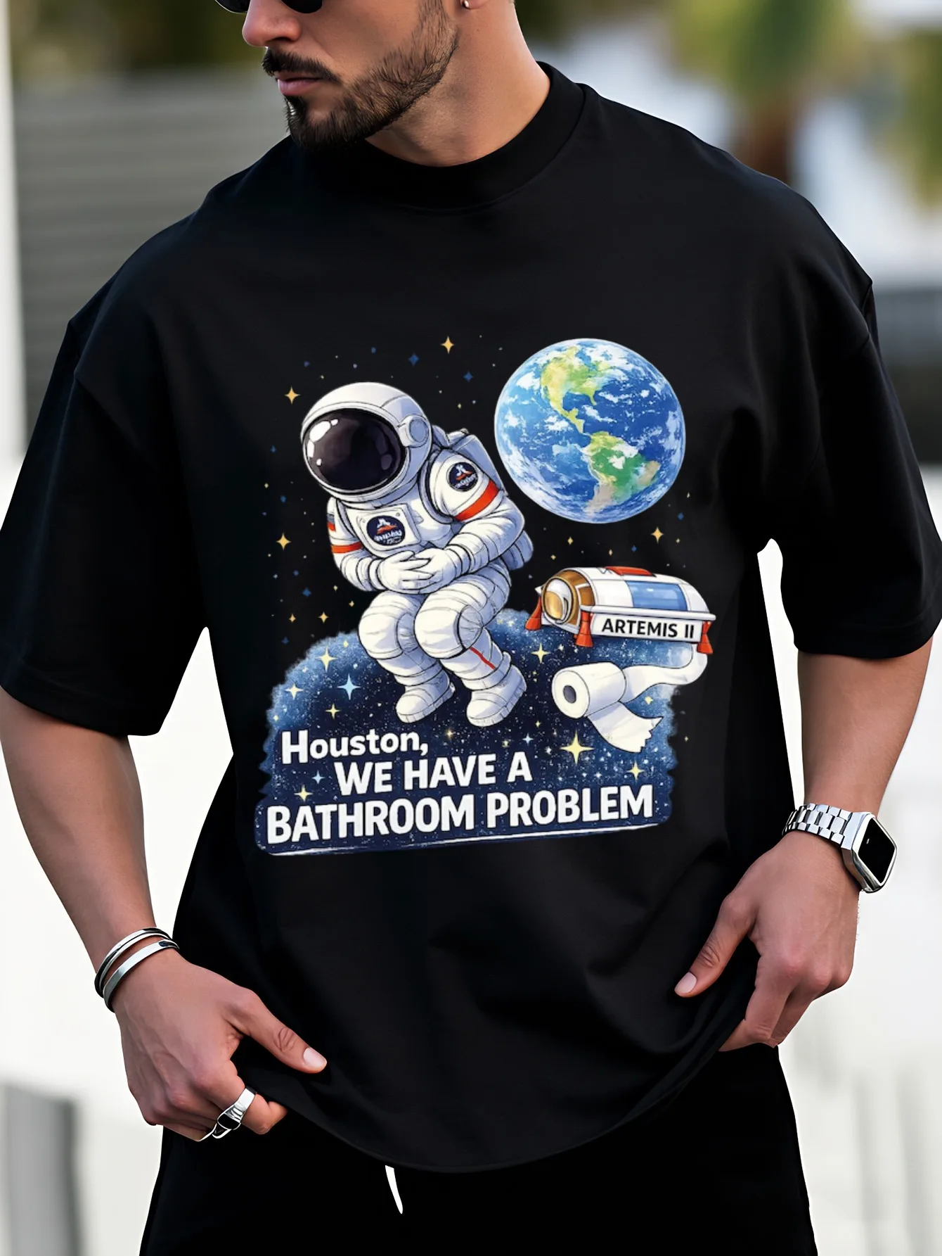 New Style Funny Unisex T-Shirt Black Astronaut Holding Toilet Paper with Earth And Text Houston We Have A Bathroom Problem Space Theme Design Perfect for Casual Wear And Holiday Gifts  Fashionable And Versatile Daily Outfit Short Sleeve
