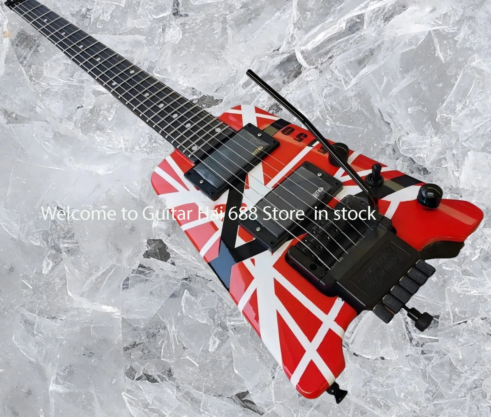 

Электрогитара безголовая, красно-бело-черная, с полосками, с звукоснимателями EMG, тремоло-бриджем, черной фурнитурой. # 5462899