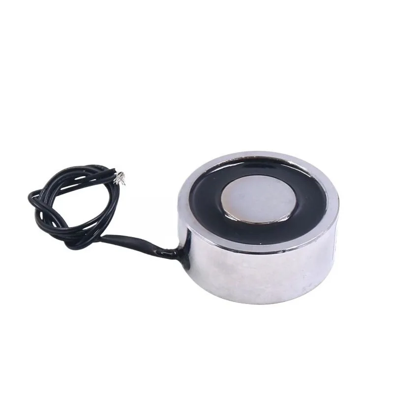 Small circular electromagnetic chuck generates magnetic force when powered, electromagnetic iron