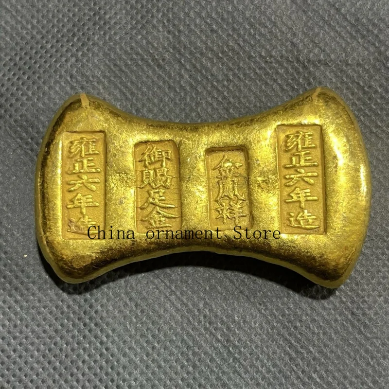Vintage solid gold ingot coins, made during the Yongzheng reign, featuring a design of a golden phoenix and auspicious symbols,