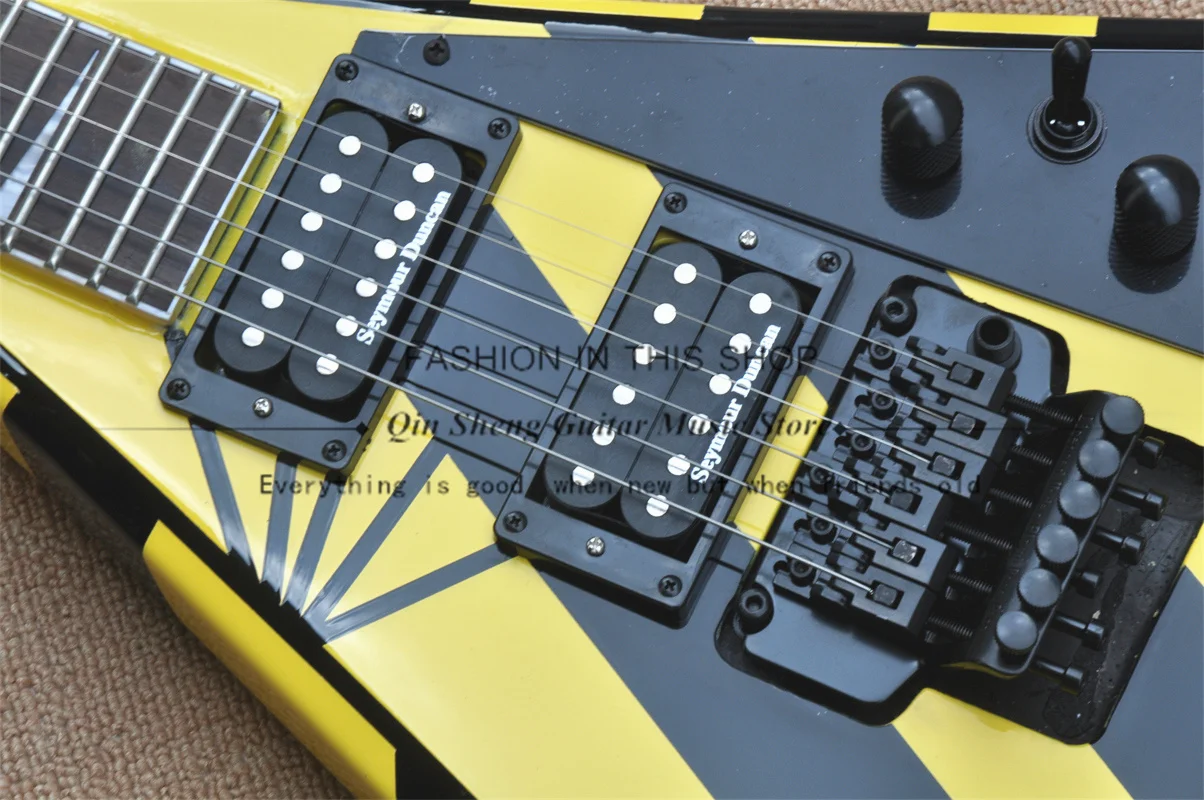Black-yellow electric guitar, V-shaped guitar, tremolo bridge, black and yellow striped body, HH pickups, rosewood fretboard