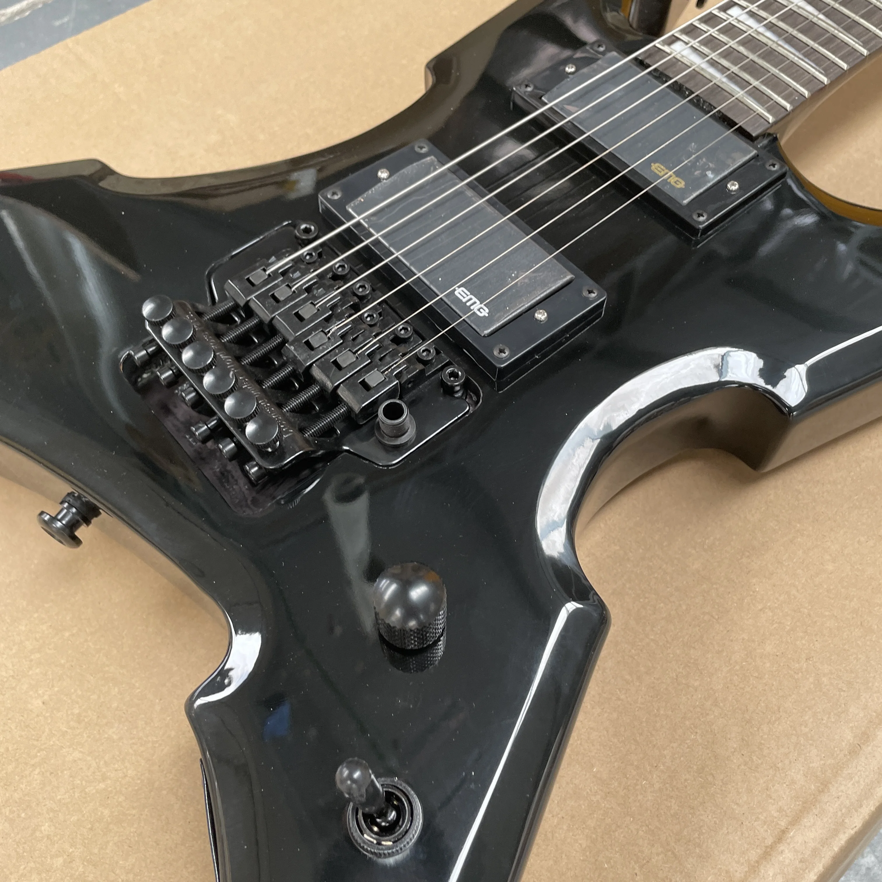 Six-string black electric guitar with mahogany body, tremolo system, and black hardware guitars—unique styled electric guitarra