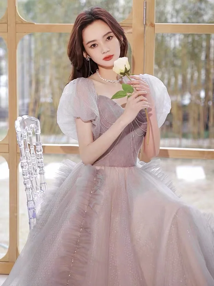 Splendido abito da sera viola rosa Elegante abito da festa formale da donna lungo con perline e maniche a sbuffo in tulle sexy senza schienale con lacci