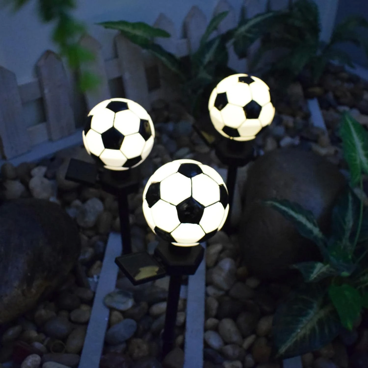 Sleek and sophisticated soccer ball-shaped solar pathway stake lamp, perfect for hosting sports-themed backyard gatherings. Add 