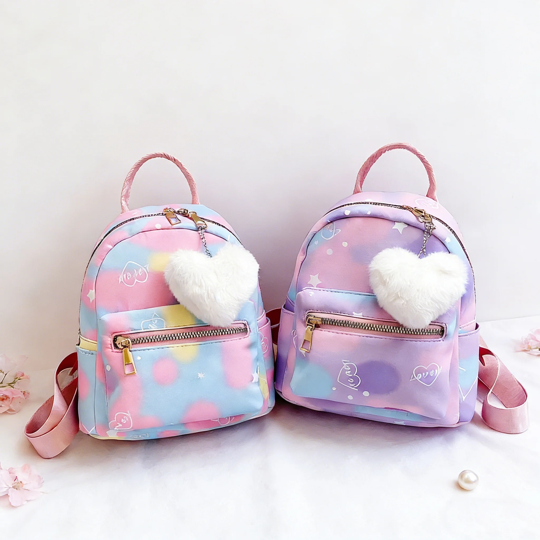 

Stylish travel nylon backpack with contrasting colors and a heart-shaped pendant, perfect as a casual mom bag or student school