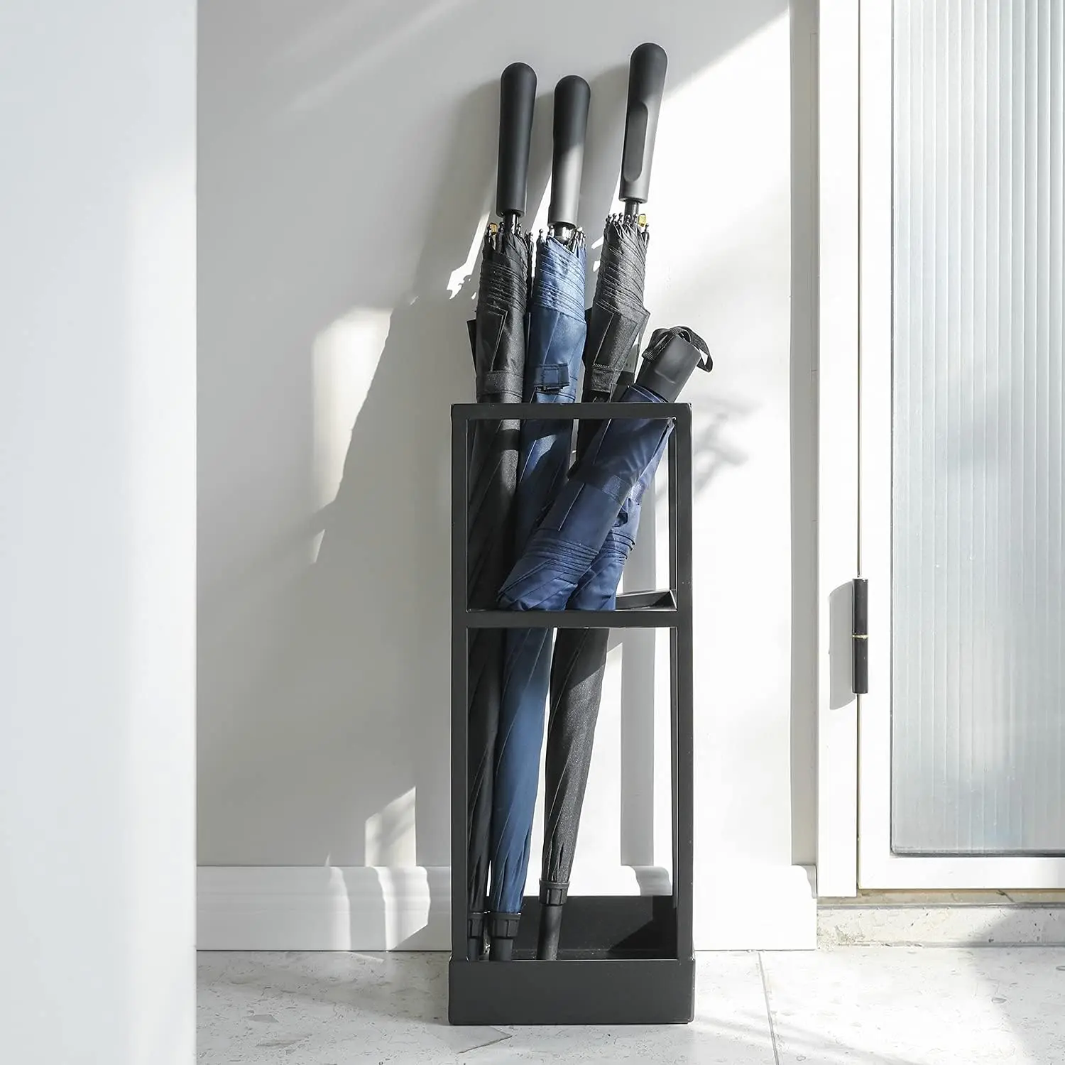 Modern black metal umbrella stand or cane stand with small umbrella stand and bottom drip stand.