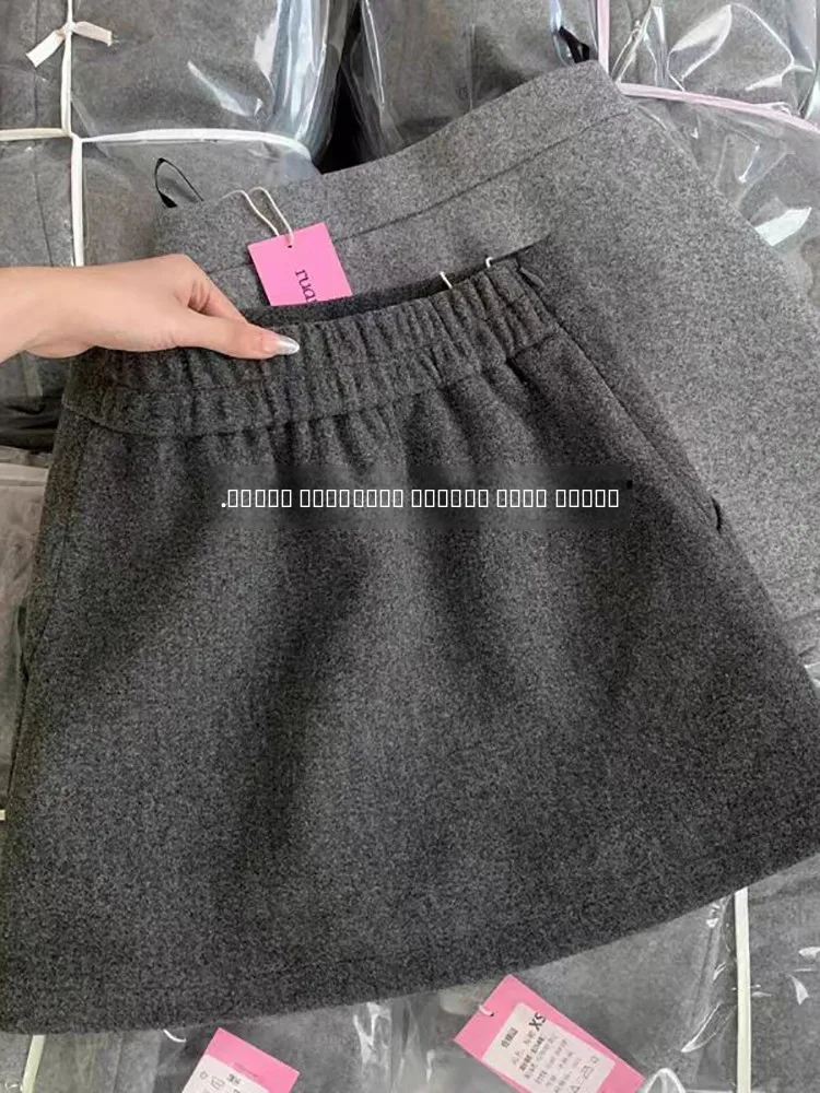 Falda de lana a la moda para mujer, cintura alta, corte en A, corta, que evita la exposición, para otoño e invierno, estilo coreano.