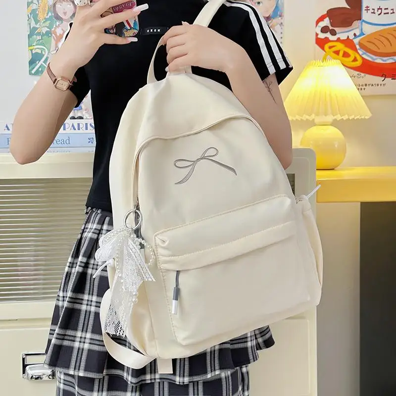 กระเป๋าเป้สะพายหลังสีพื้นน่ารักสไตล์เกาหลี ความจุเยอะ น้ำหนักเบา เหมาะสำหรับเดินทาง ปักลายโบว์  กระเป๋านักเรียน ของขวัญ