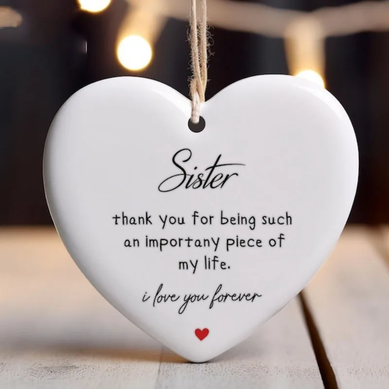 

A heart-shaped souvenir of a sister's Christmas decoration, with an elegant "I love you" message and red accents on a tree